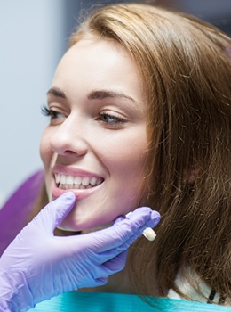 A dentist looking at a female patient’s smile