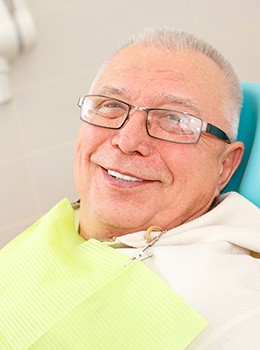 Older man smiling in dental chair
