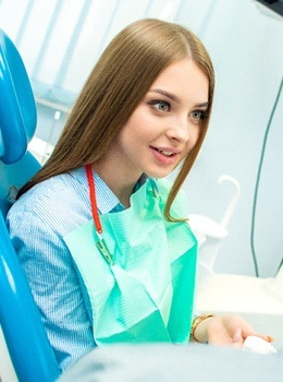A young woman talking to her dentist